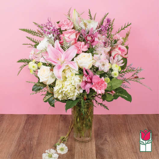 Pink and white mixed flower arrangement in a glass vase
