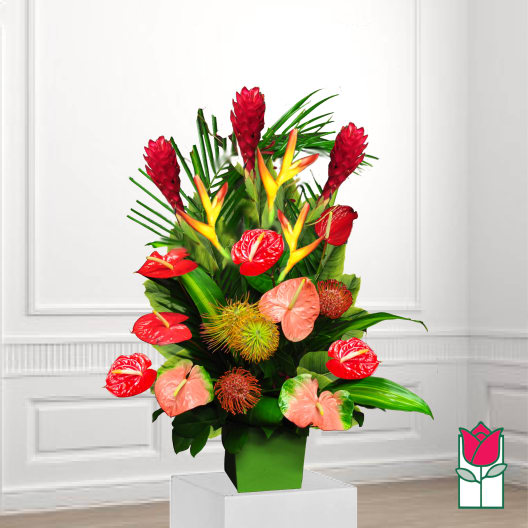 Tropical arrangement with red anthuriums and orange bird-of-paradise in a green vase