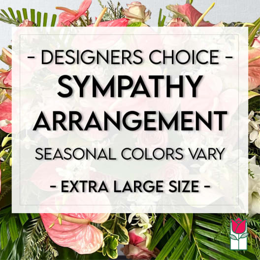 Sympathy arrangement with pink flowers and tropical leaves
