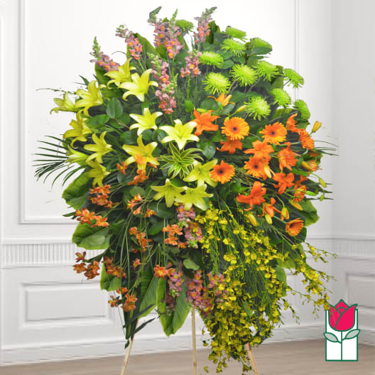 Large standing floral spray with lilies, gerbera daisies, and orchids