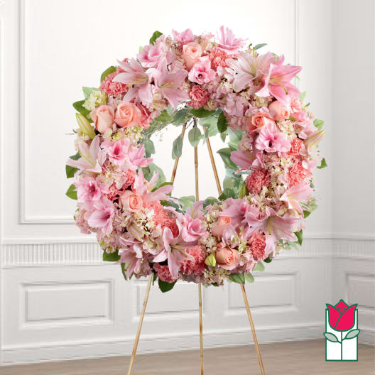 Pink floral wreath on a gold stand