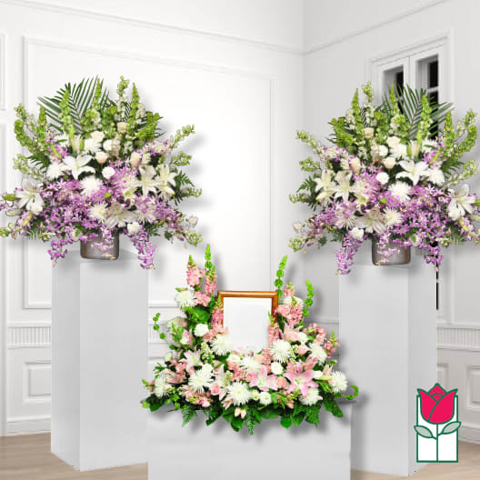 Three floral arrangements with pink, white, and purple flowers on white pedestals