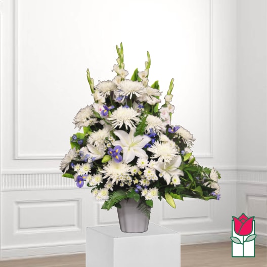 White and purple floral arrangement in a gray vase