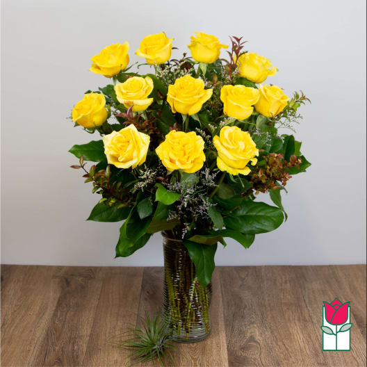 Yellow roses arranged in a clear glass vase
