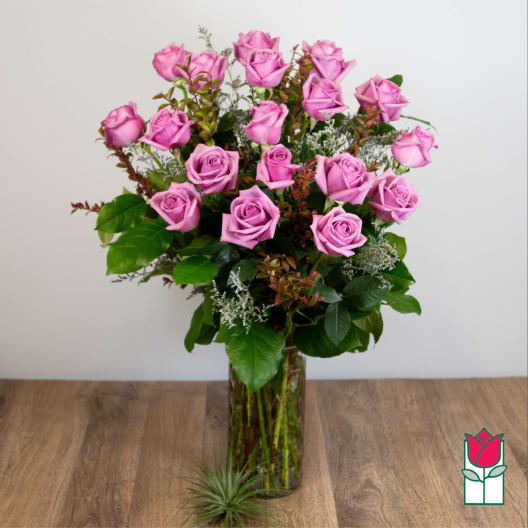Pink roses arranged in a clear glass vase