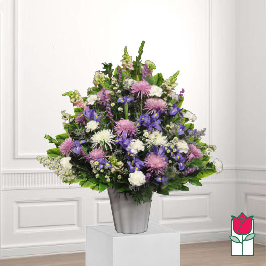 Mixed purple and white floral arrangement in a silver vase