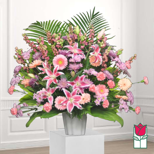 Pink and lavender mixed flower arrangement in a silver vase