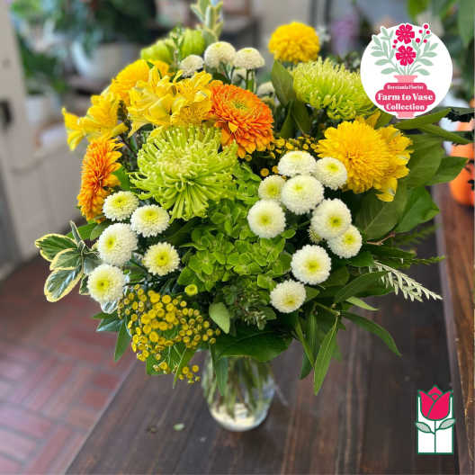 Yellow and white mixed flower bouquet in a glass vase
