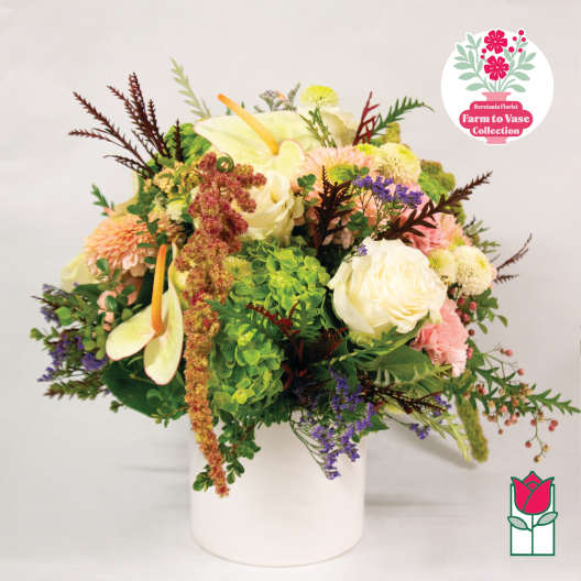 Mixed bouquet in a white vase with white and pink blooms