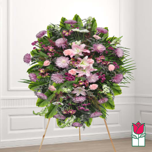 Large standing floral spray with pink lilies and purple blooms