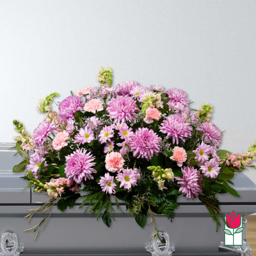 Pink and lavender floral casket spray with daisies and carnations