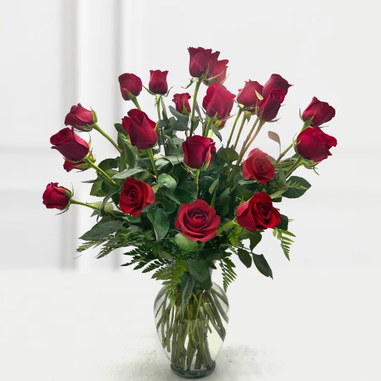 Red roses arranged in a clear glass vase