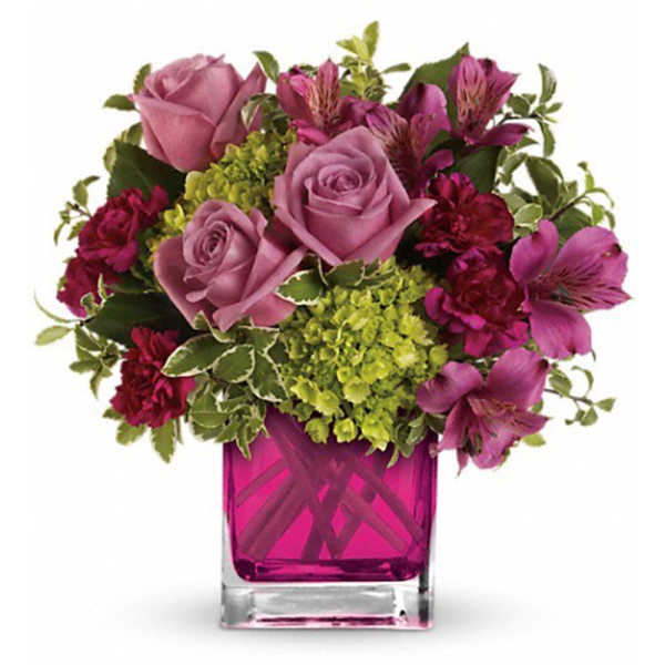 Pink roses and purple flowers in a magenta glass vase