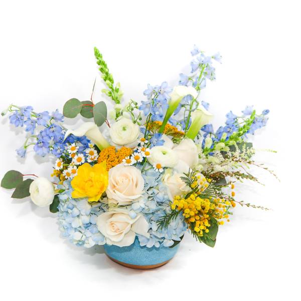 Blue and white floral arrangement in a blue vase