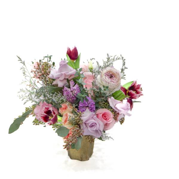 Bouquet of pink and lavender flowers in a gold vase