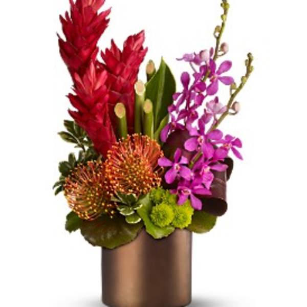 Tropical arrangement with red ginger, pink orchids, orange protea, and green mums in a bronze cylinder vase
