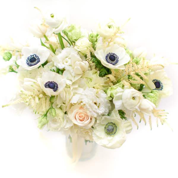 White bouquet with anemones, roses, and pale filler flowers