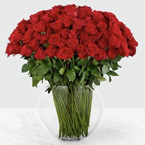 Large bouquet of red roses in a clear glass vase