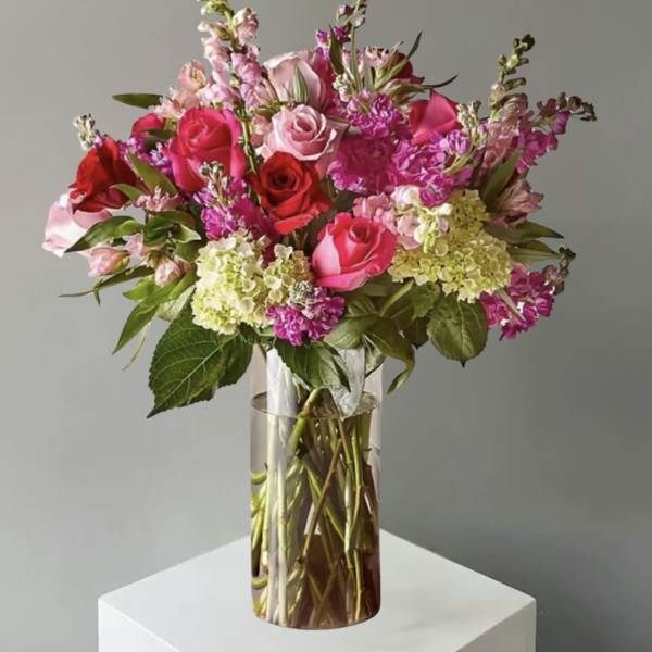 Pink and red rose bouquet in a clear glass vase