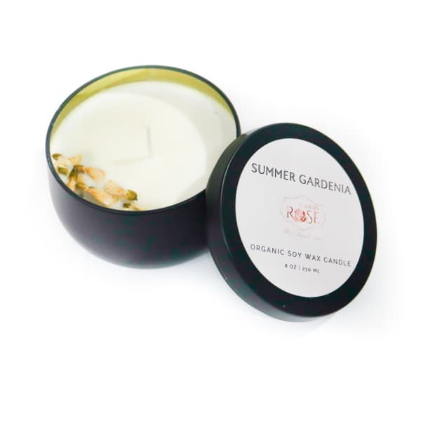 Black tin candle with a lid labeled Summer Gardenia Rose