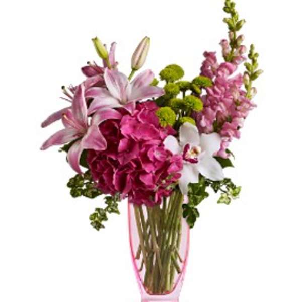 Pink and white floral arrangement in a pink glass vase