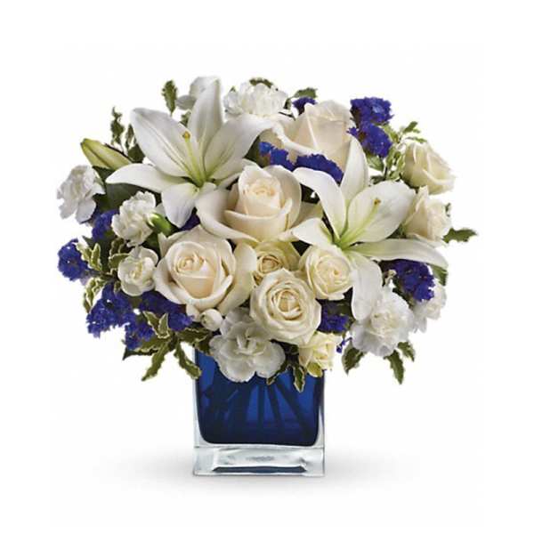 White lilies and roses in a blue glass vase