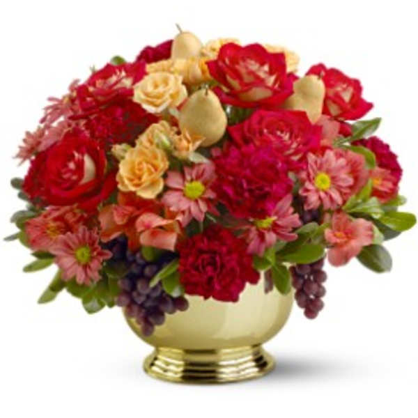 Low gold bowl arrangement of red roses, pink mums, peach roses and fruit accents