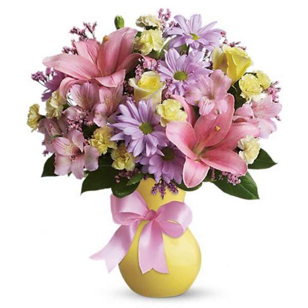 Pink and lavender bouquet in a yellow vase with a pink ribbon
