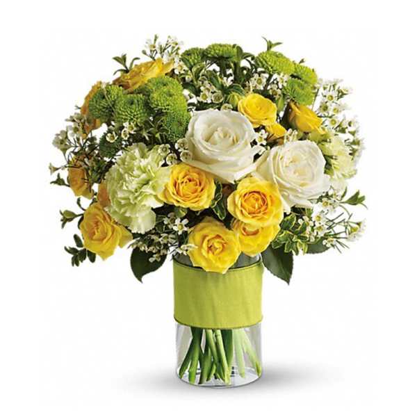Yellow and white roses in a clear glass vase