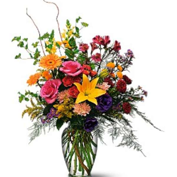 Colorful mixed flower arrangement in a clear glass vase