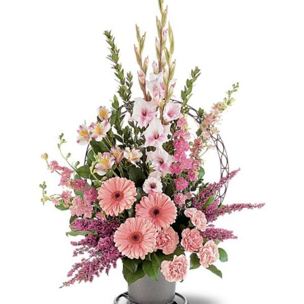 Tall pink and white floral arrangement with gerbera daisies and carnations in a gray vase