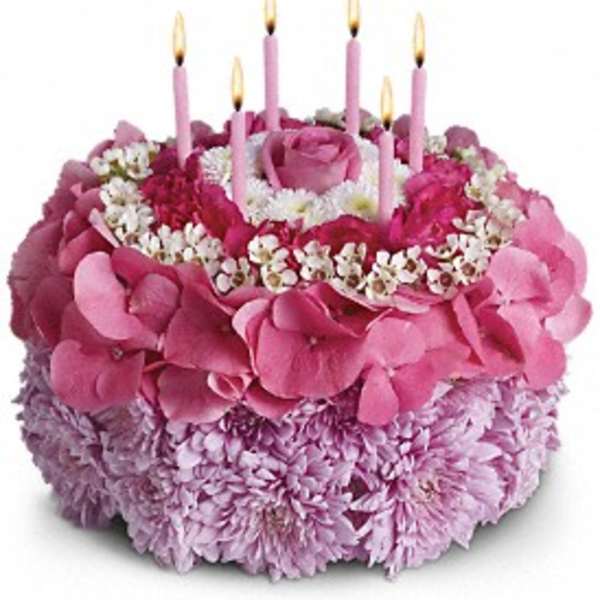 Pink floral cake with five lit candles