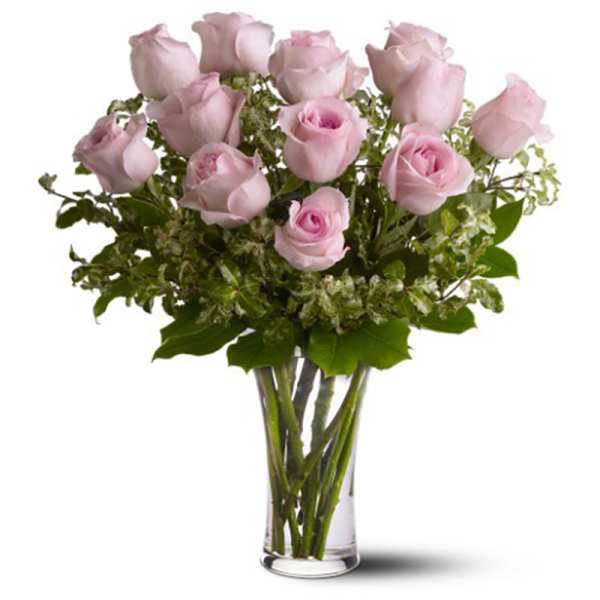 Pink roses arranged in a clear glass vase