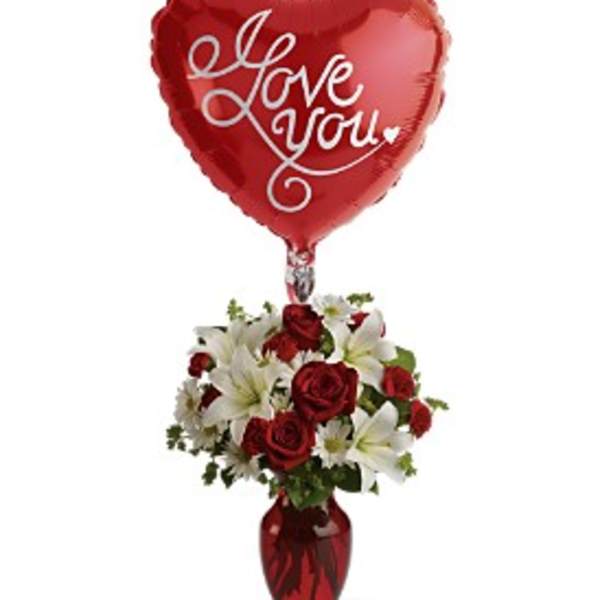 Heart-shaped red balloon above a red and white rose bouquet in a vase