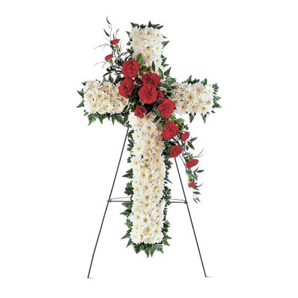 Standing cross-shaped arrangement of white mums with red carnations on a metal easel