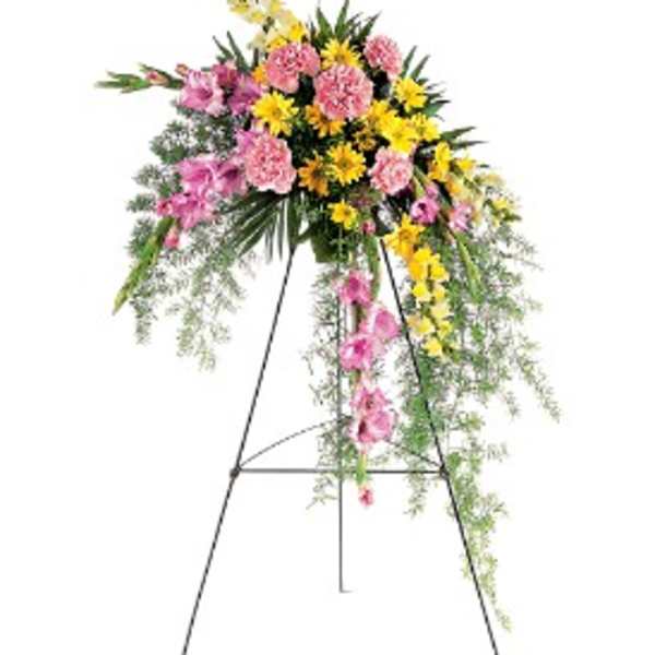 Tall standing spray of pink and yellow flowers on a black metal easel
