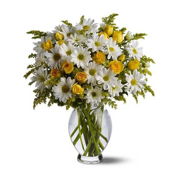 Yellow roses and white daisies in a clear glass vase
