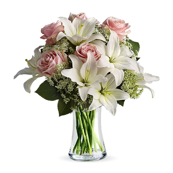 Pink roses and white lilies in a clear glass vase