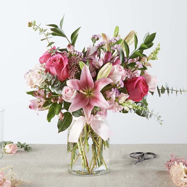 Pink and white floral bouquet in a clear glass vase