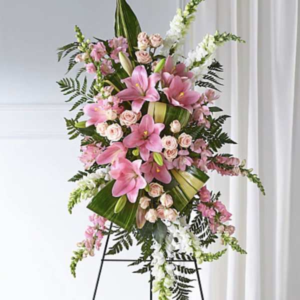 Standing floral spray with pink lilies, roses, and white snapdragons