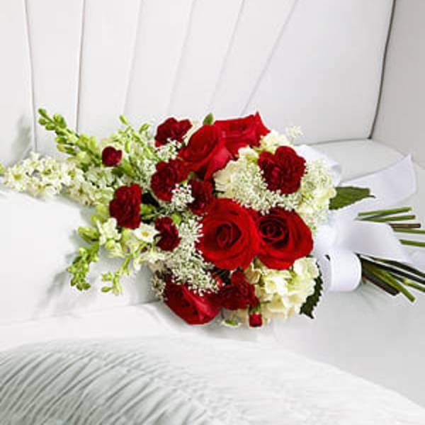 Red roses and white flowers arranged in a bouquet