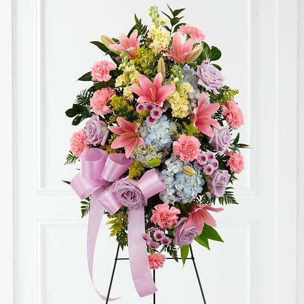 Standing floral spray with pink lilies, hydrangeas, roses, and carnations