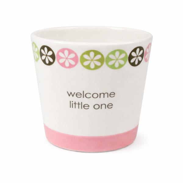 White ceramic cup with "welcome little one" text and pink-green floral border