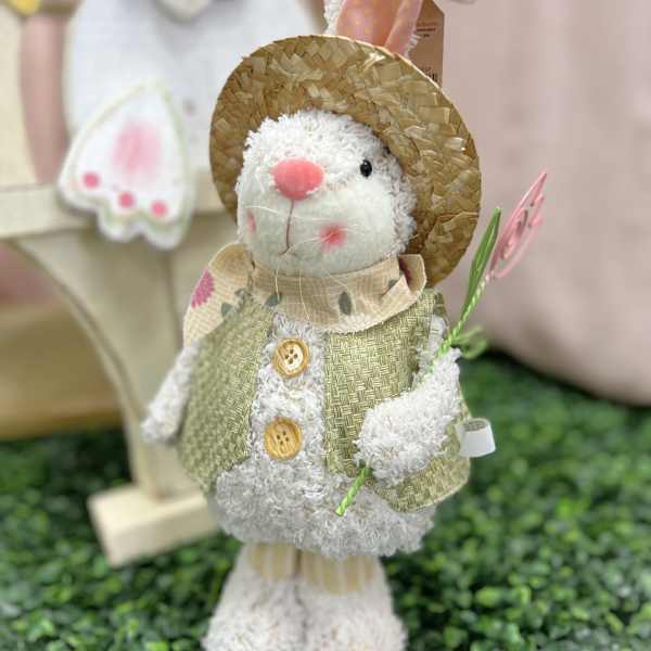 Plush bunny figurine in a straw hat and vest holding a flower