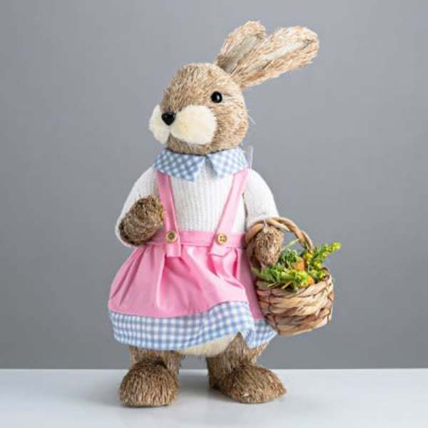 Easter bunny figurine holding a basket of flowers