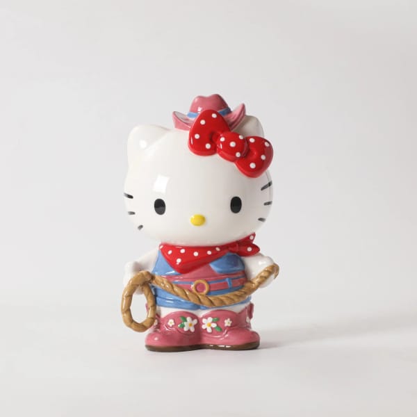 Ceramic Hello Kitty figurine dressed as a cowboy with a rope
