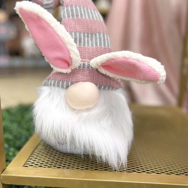 Decorative gnome figurine with pink striped hat and bunny ears