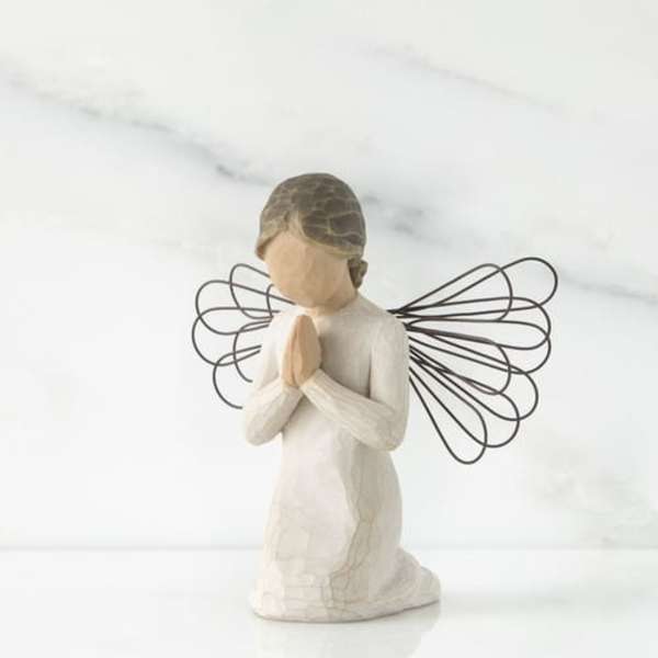 Small angel figurine with folded hands and wire wings