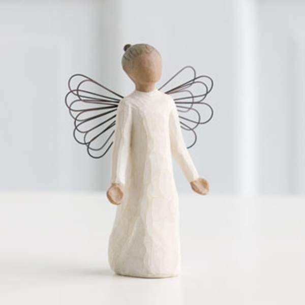 Carved wooden angel figurine in a long white dress with delicate wire wings.