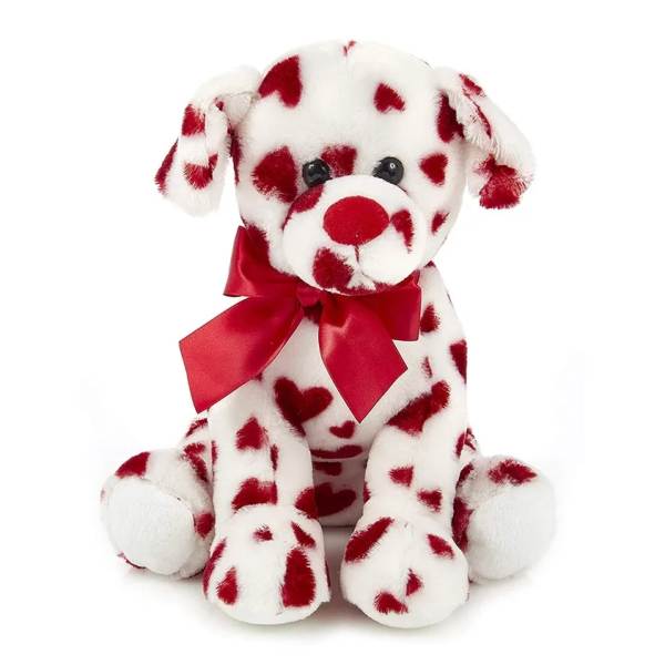 Plush dog with red heart pattern and a red ribbon bow